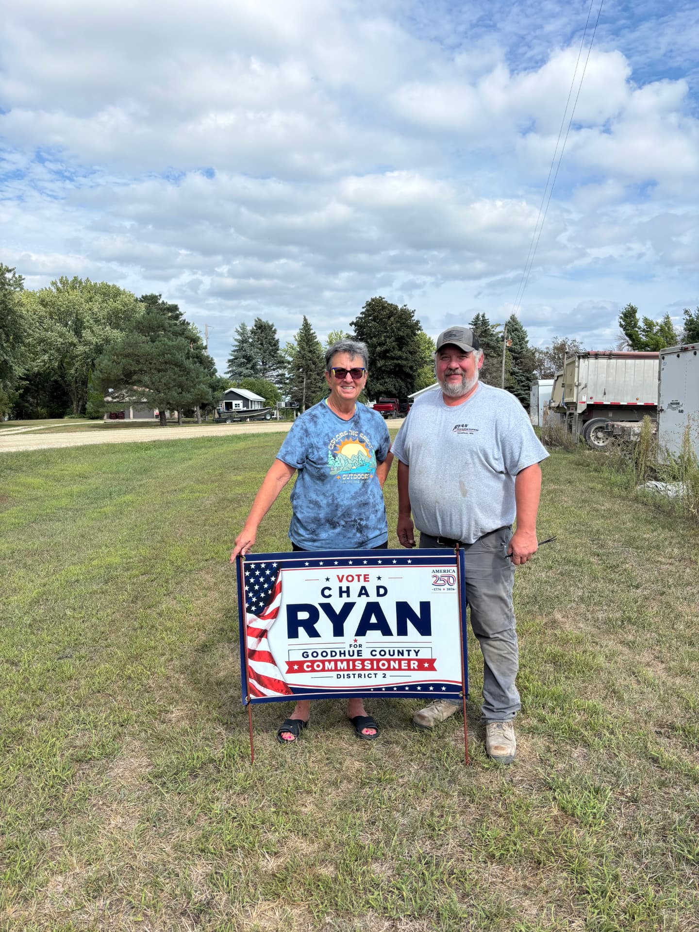 Chad Ryan and a supporter putting up a Chad Ryan for Goodhue County Commissioner District 2 yard sign in Goodhue Minnesota.