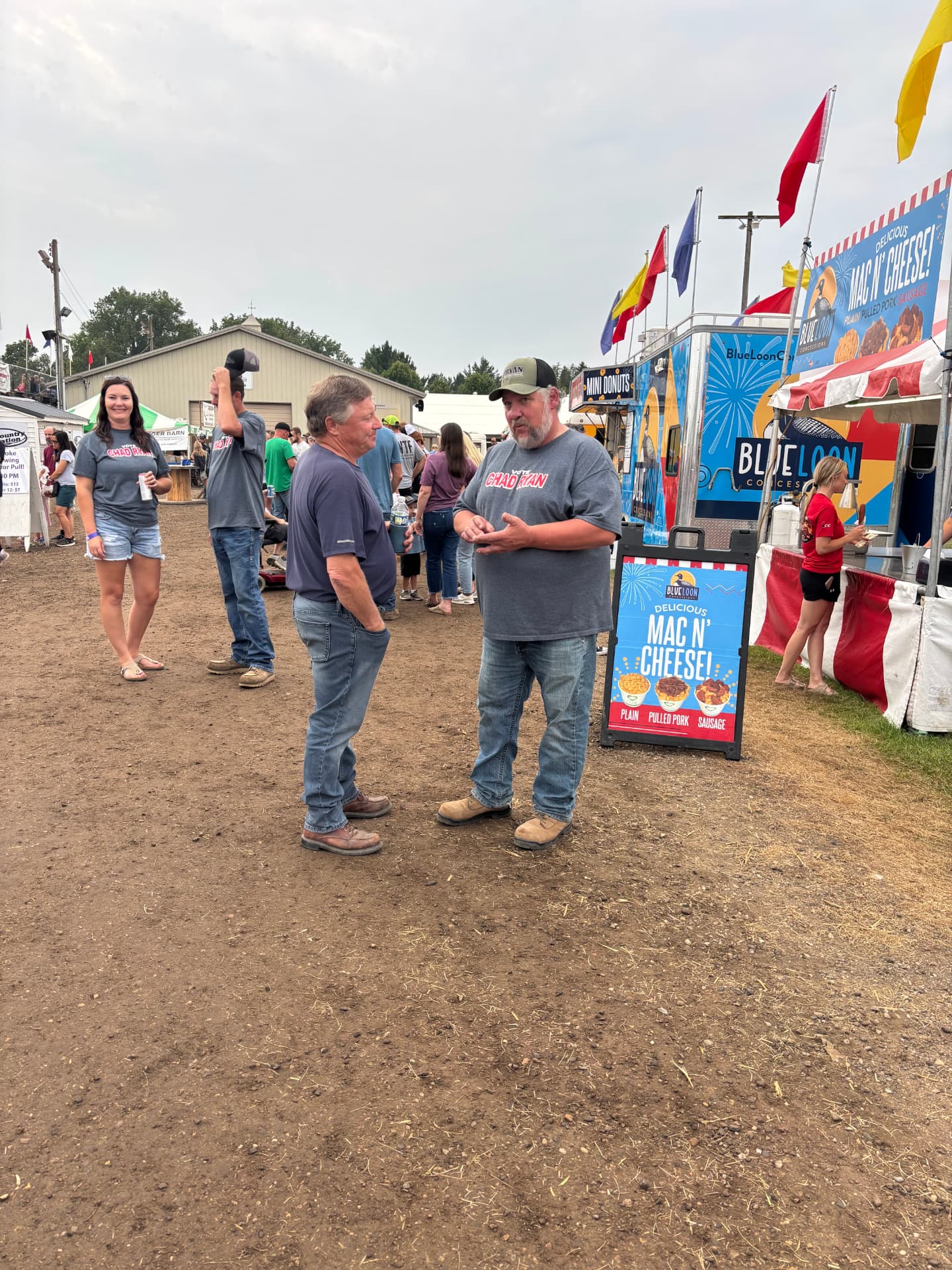 Chad Ryan talking with a neighbor at the Goodhue County Fair in Minnesota.